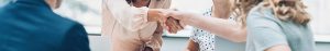 Two people shaking hands in a meeting