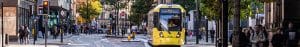 View on a street in central Manchester with people and a tram