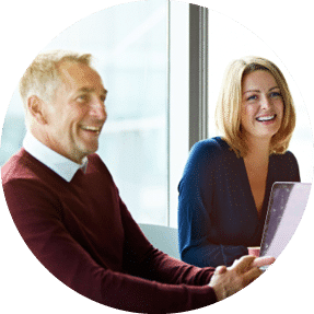 Two colleagues smiling in a meeting