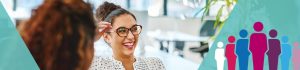 Woman talking with colleague in office and laughing