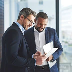 Two business-people examining a tablet