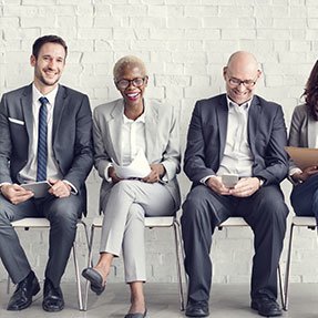 Cheerful colleagues sat in a row