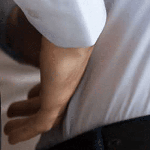 Office worker rubbing lower back