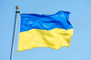 Flag of Ukraine blowing in the wind against a blue sky