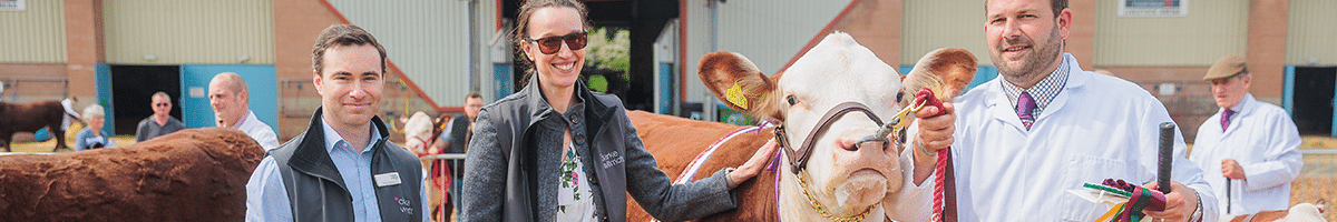 Field Talk Roadshow 9 CW staff posing with farmers and cattle at a county show competition