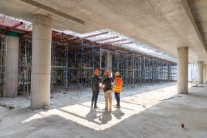 Construction concept of Engineer and Architect working at Construction Site with blue print