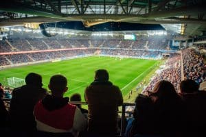 Fans watching the game at soccer stadium, football photo